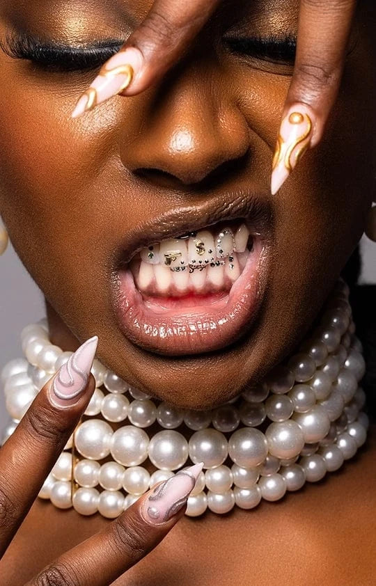 Model wearing tooth gems with pearl accents